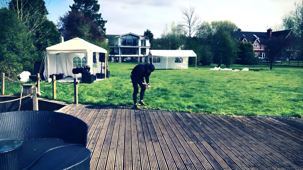 Event setup in large garden with pop-up shelters and PA gear – JET event equipment hire West Midlands