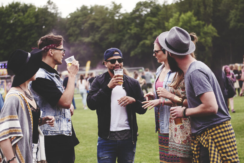 Group of friends enjoying drinks at an outdoor festival or event