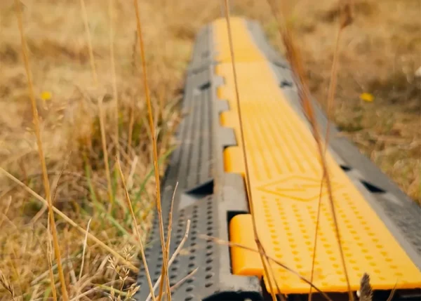 Cable protector ramp used outdoors to safely cover power and audio cables across walkways